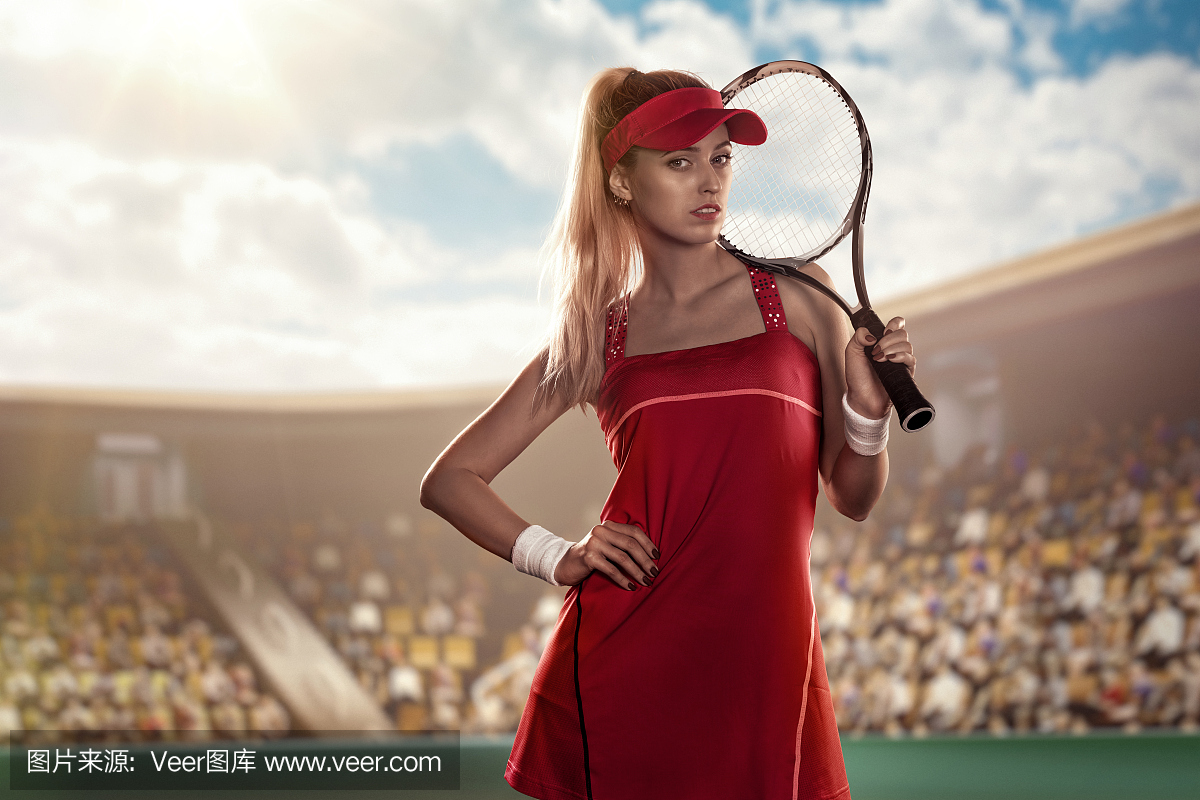 漂亮的女子网球运动员在网球场上用网球拍