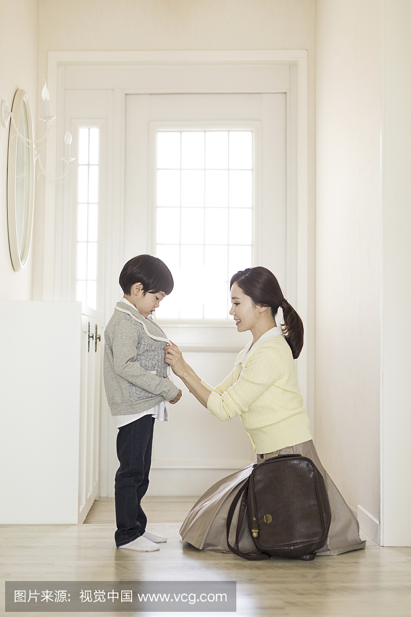 Mother Looking After Son Going To School