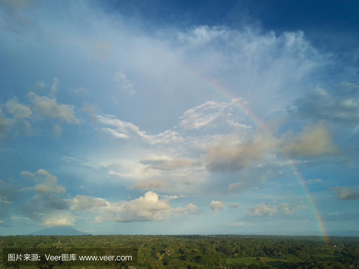Cloudy skyscape with rainbow