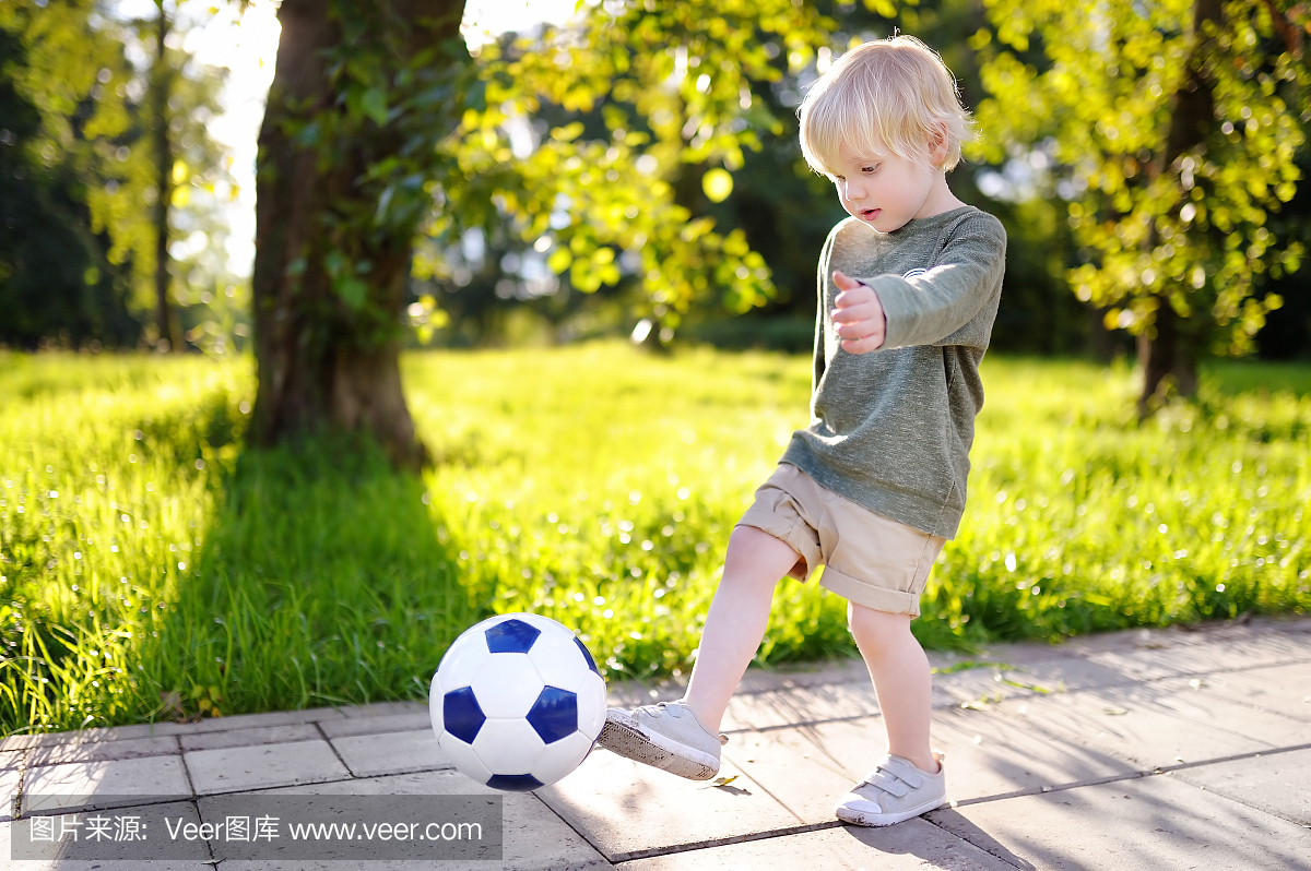 Little boy having fun playing a soccer game on 