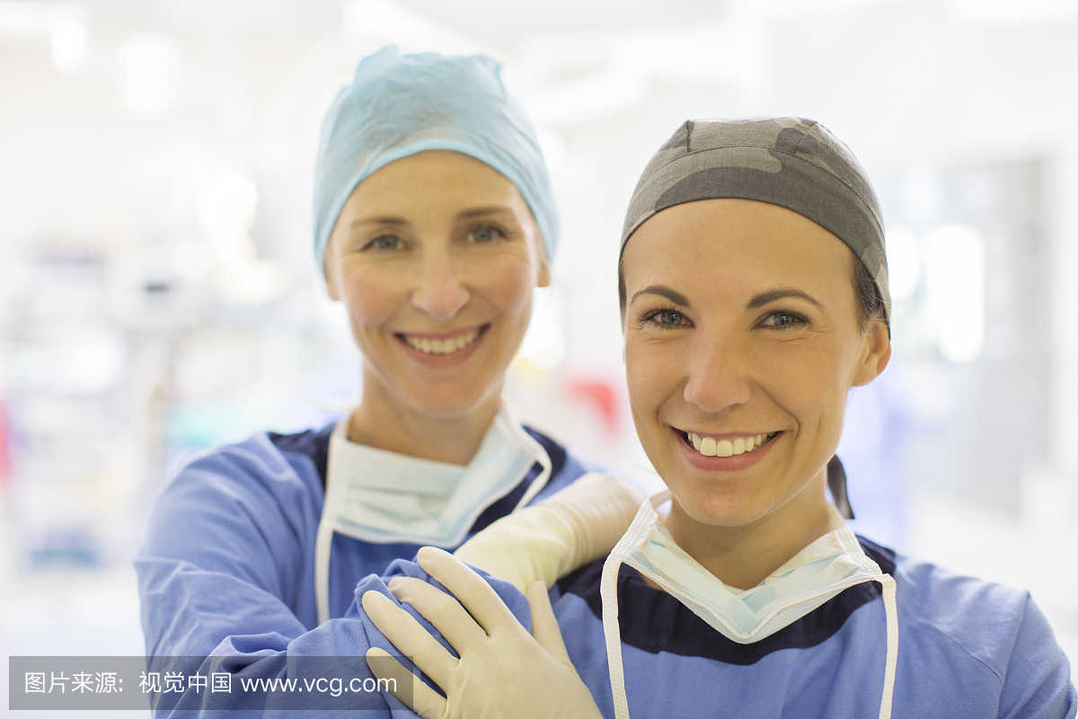 miling female doctors wearing surgical caps in 
