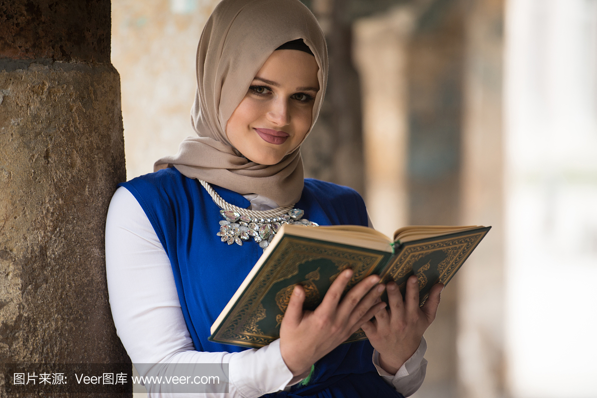 年轻的穆斯林妇女读圣经伊斯兰书古兰经