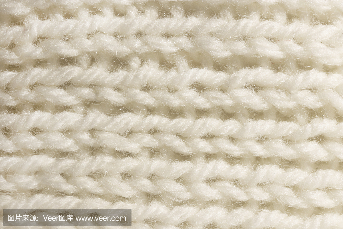 温暖的白色羊毛编织纹理。水平沿编织钩针详细