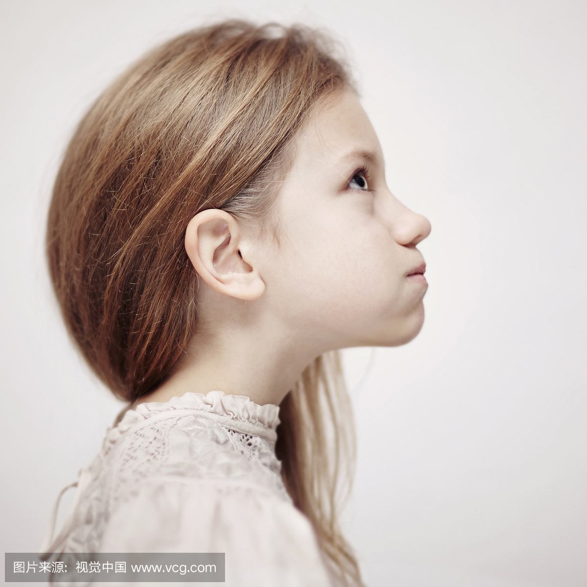 Profile of Caucasian teenage girl looking up