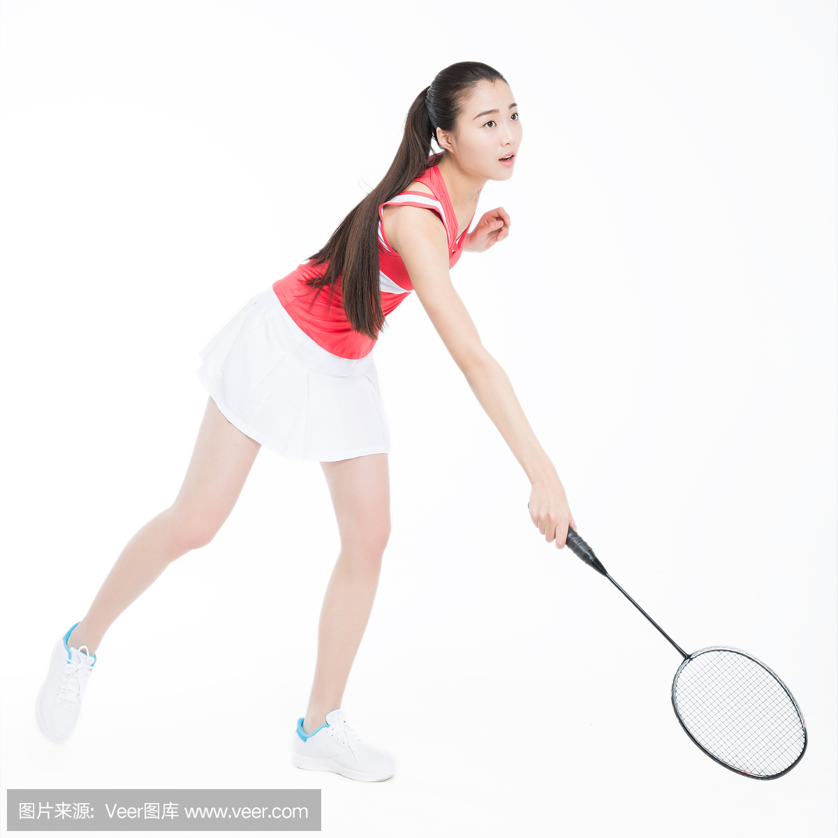 young woman playing badminton over white ba
