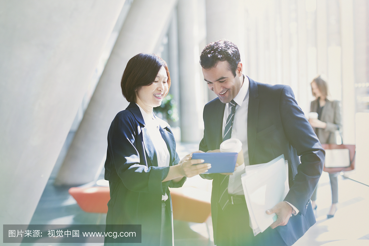 Businessman and businesswoman reviewing p