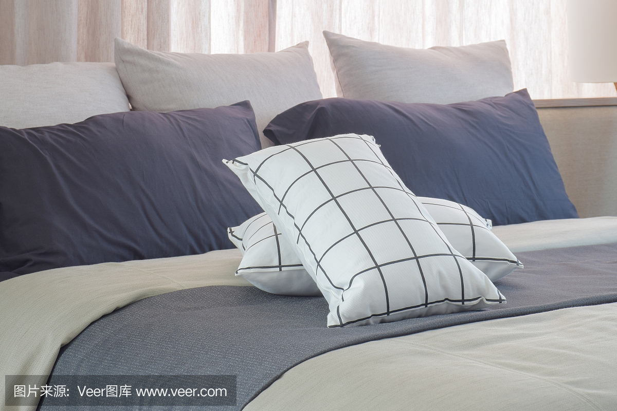 黑色和白色的枕头设置在卧室的深灰色的床上