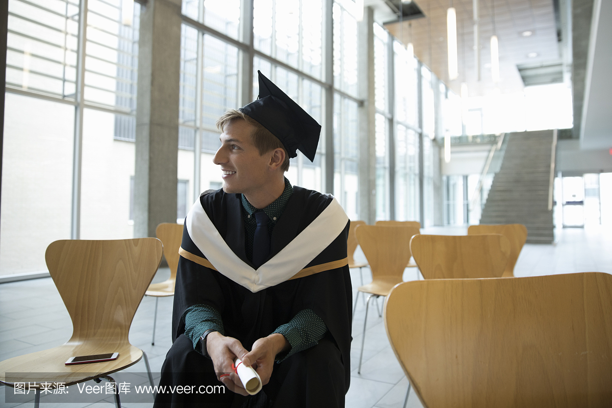 Smiling, confident male college student gradua