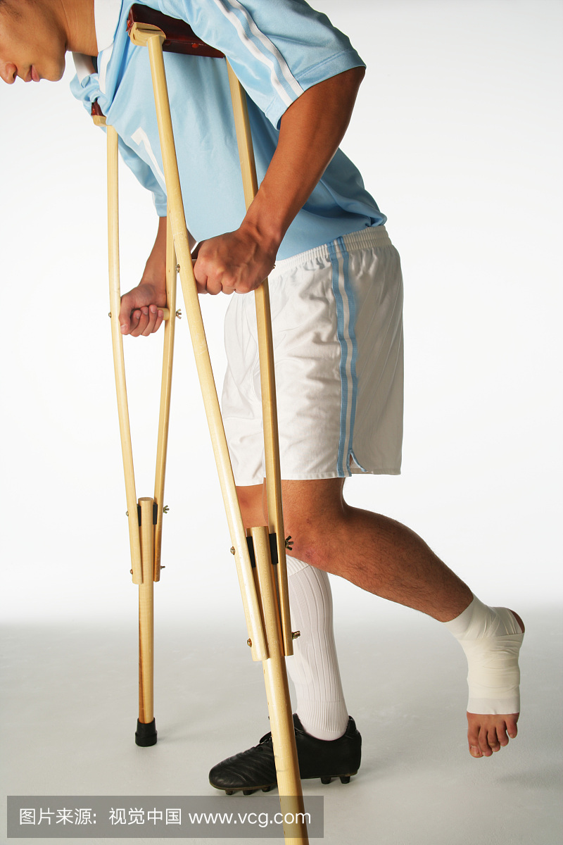 Injured soccer player using crutches