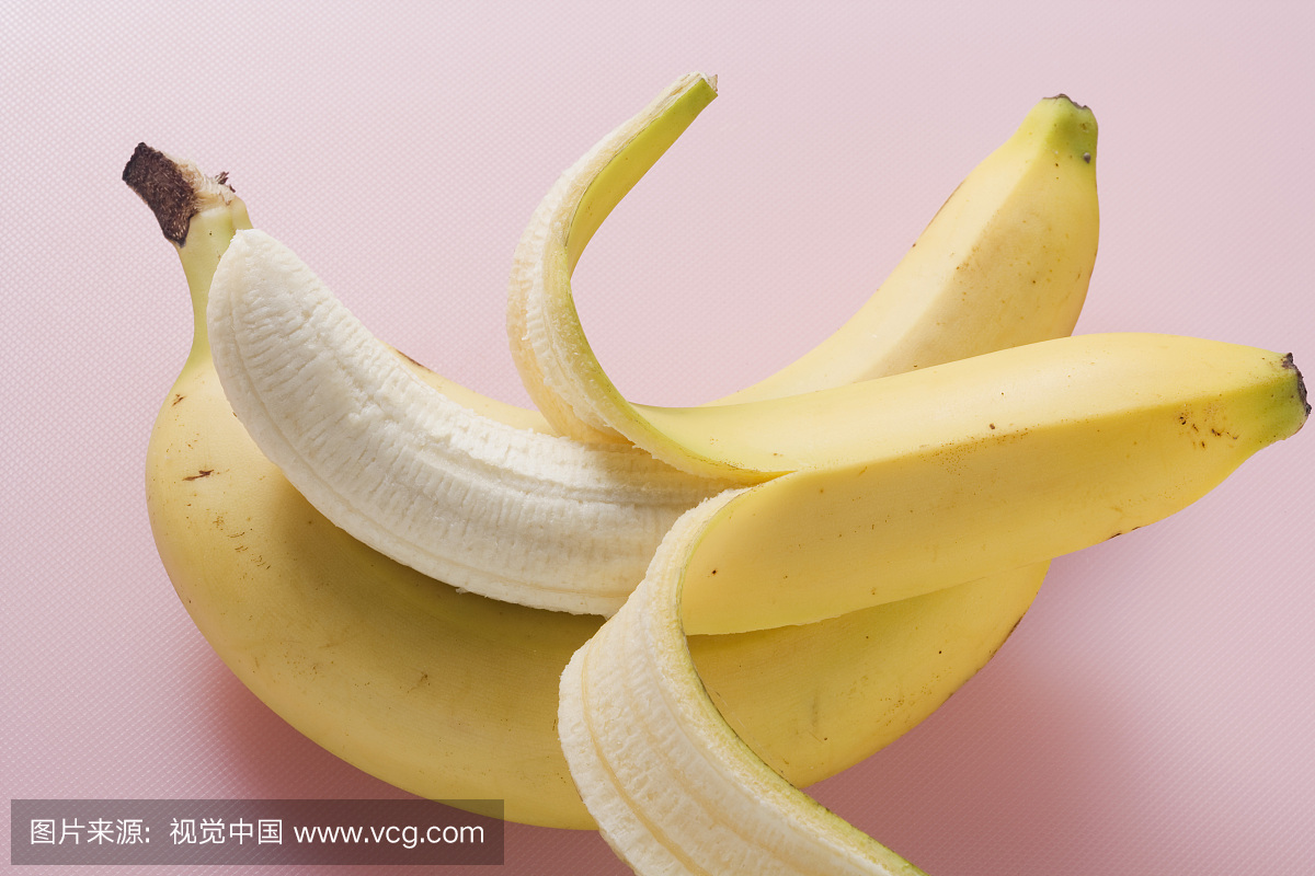Three bananas on pink background