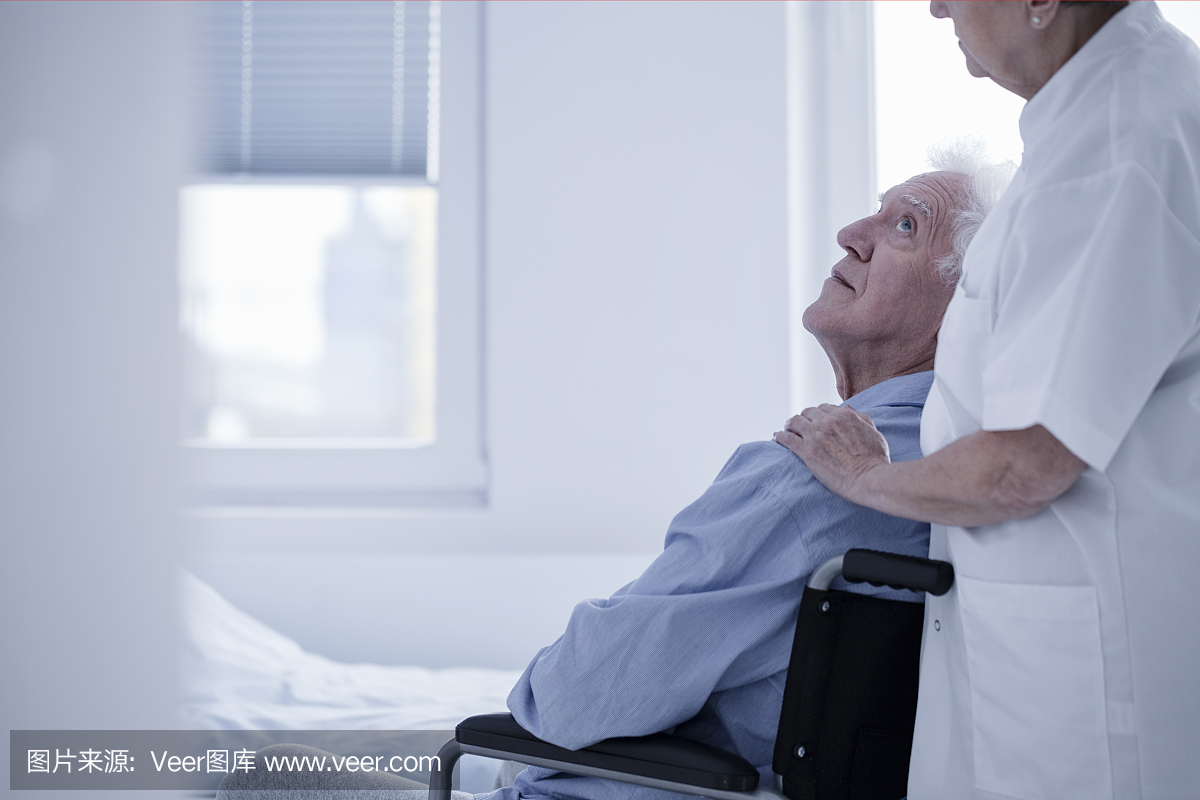 Nurse supporting disabled elderly man