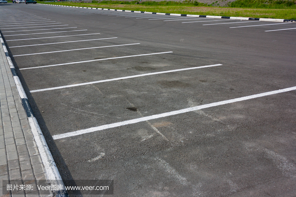 在灰色沥青停车场的背景上的白色线标记
